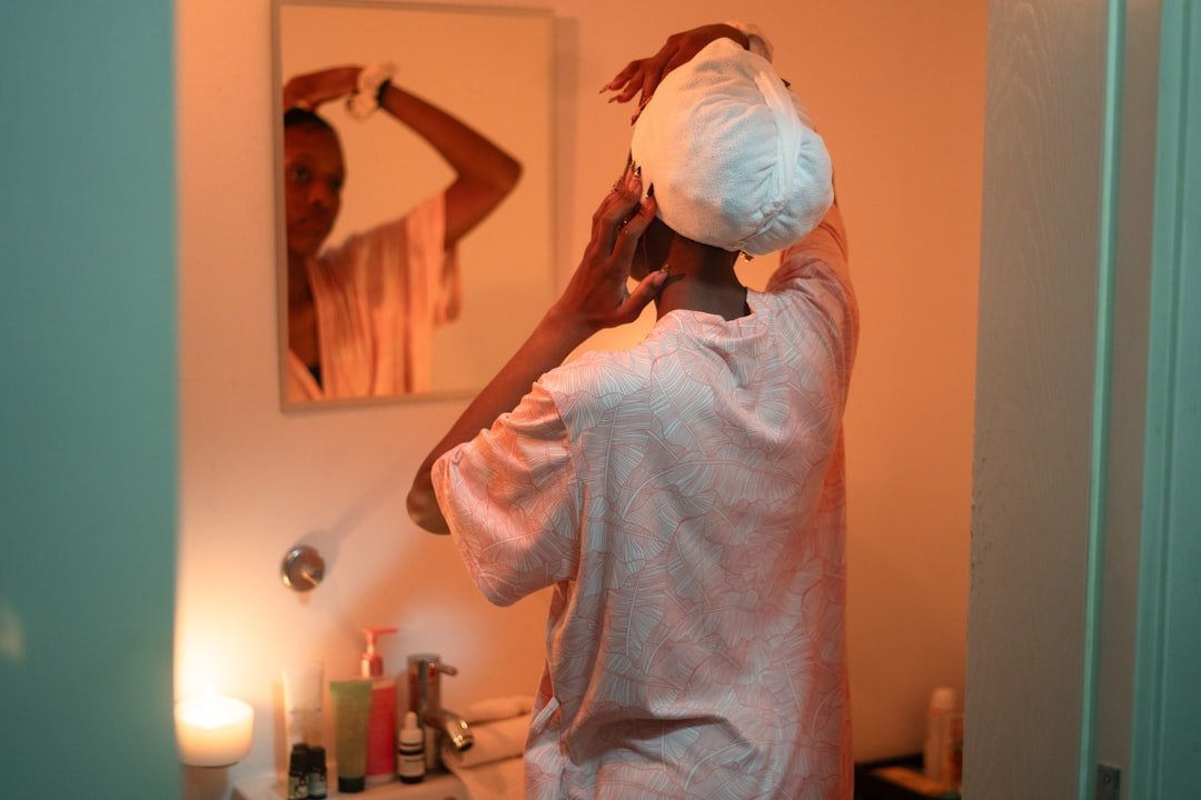 Woman washing her hair as part of a weekly routine