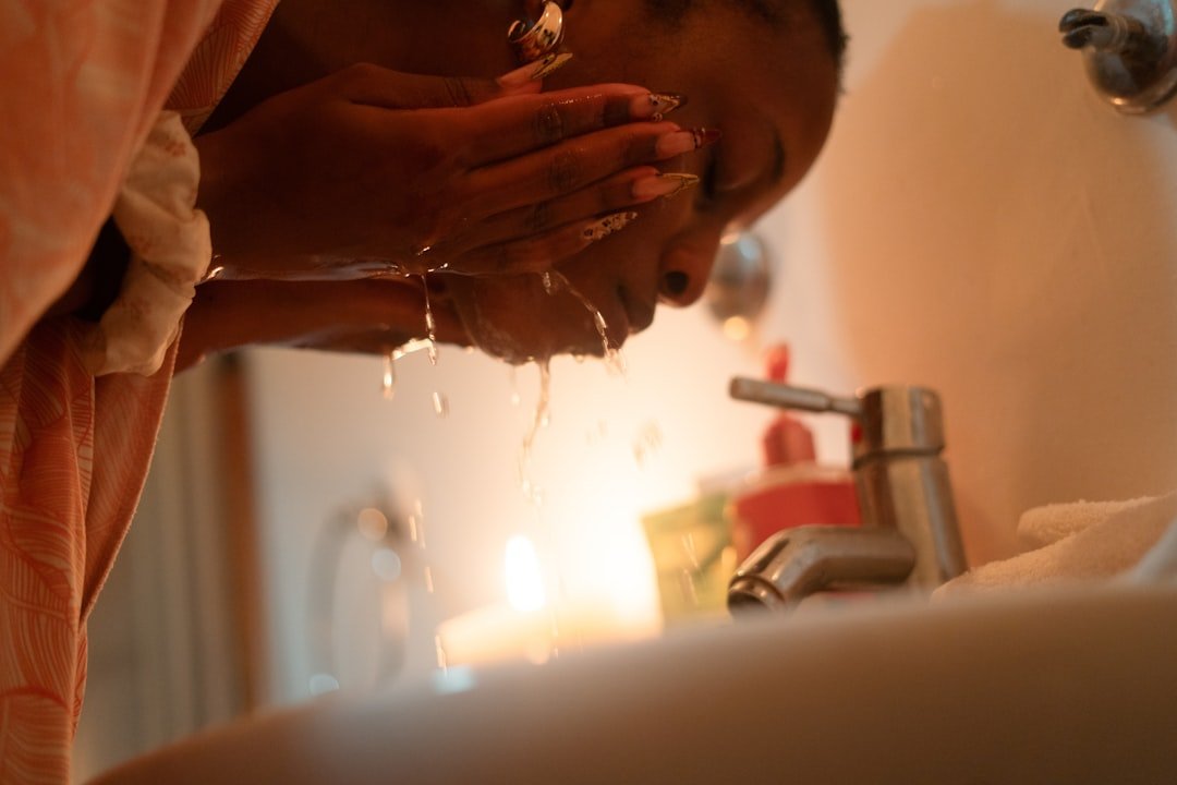 Woman washing her face with a gentle cleanser