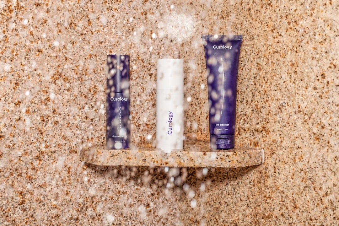 Shampoo bottles arranged on a shower shelf